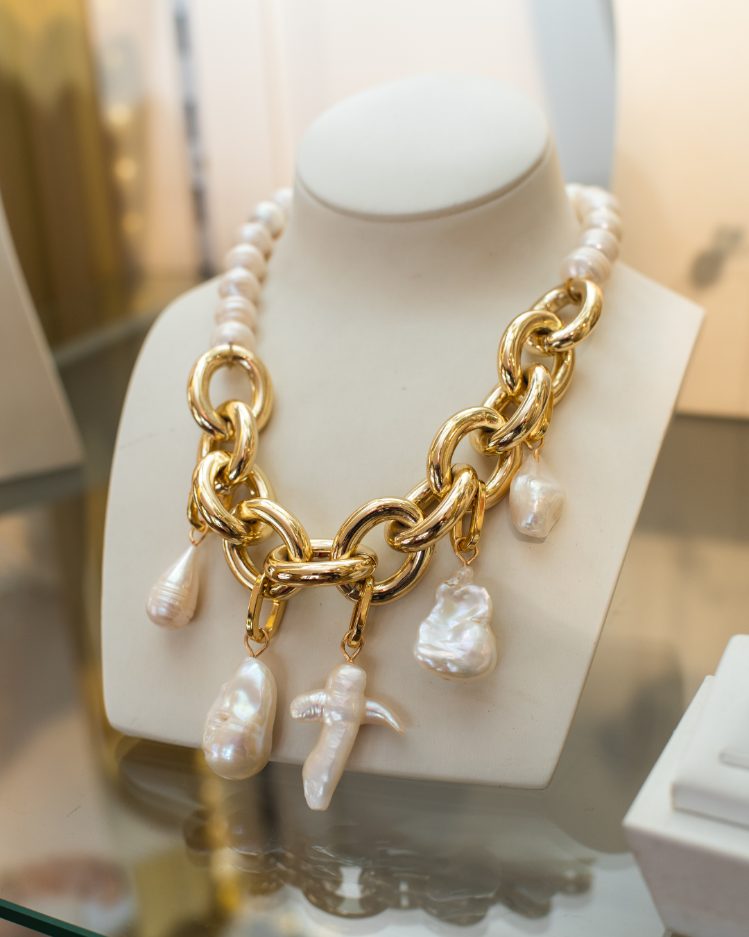Freshwater pearl necklace with chunky gold-tone chain links and baroque pearl drop charms