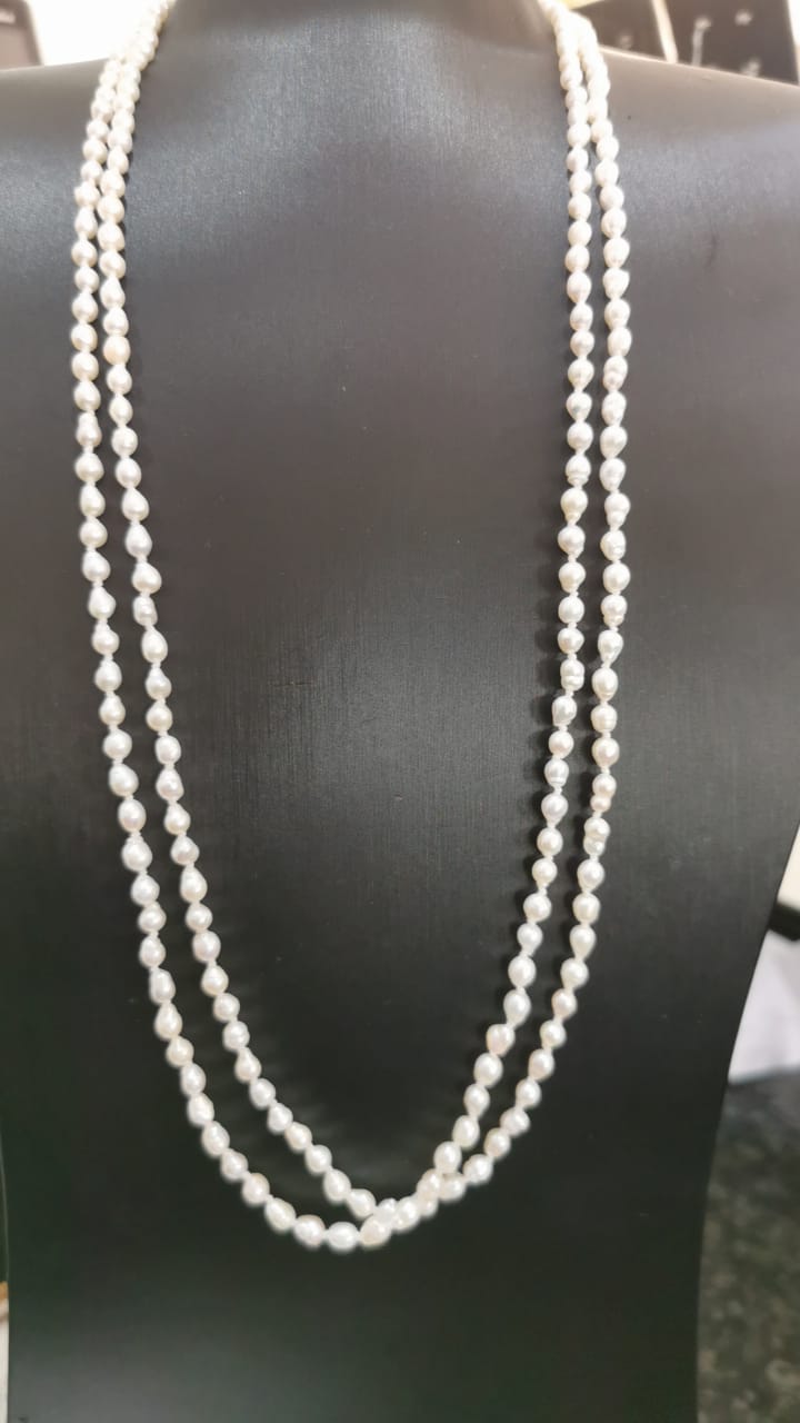 Double strand white rice pearl necklace on black bust