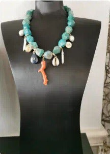 Turquoise beaded necklace with coral and charms
