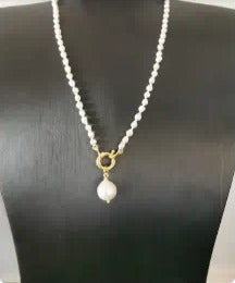 White beaded necklace with gold clasp and pearl drop