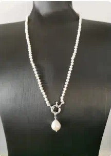 White beaded necklace with silver clasp and pearl drop